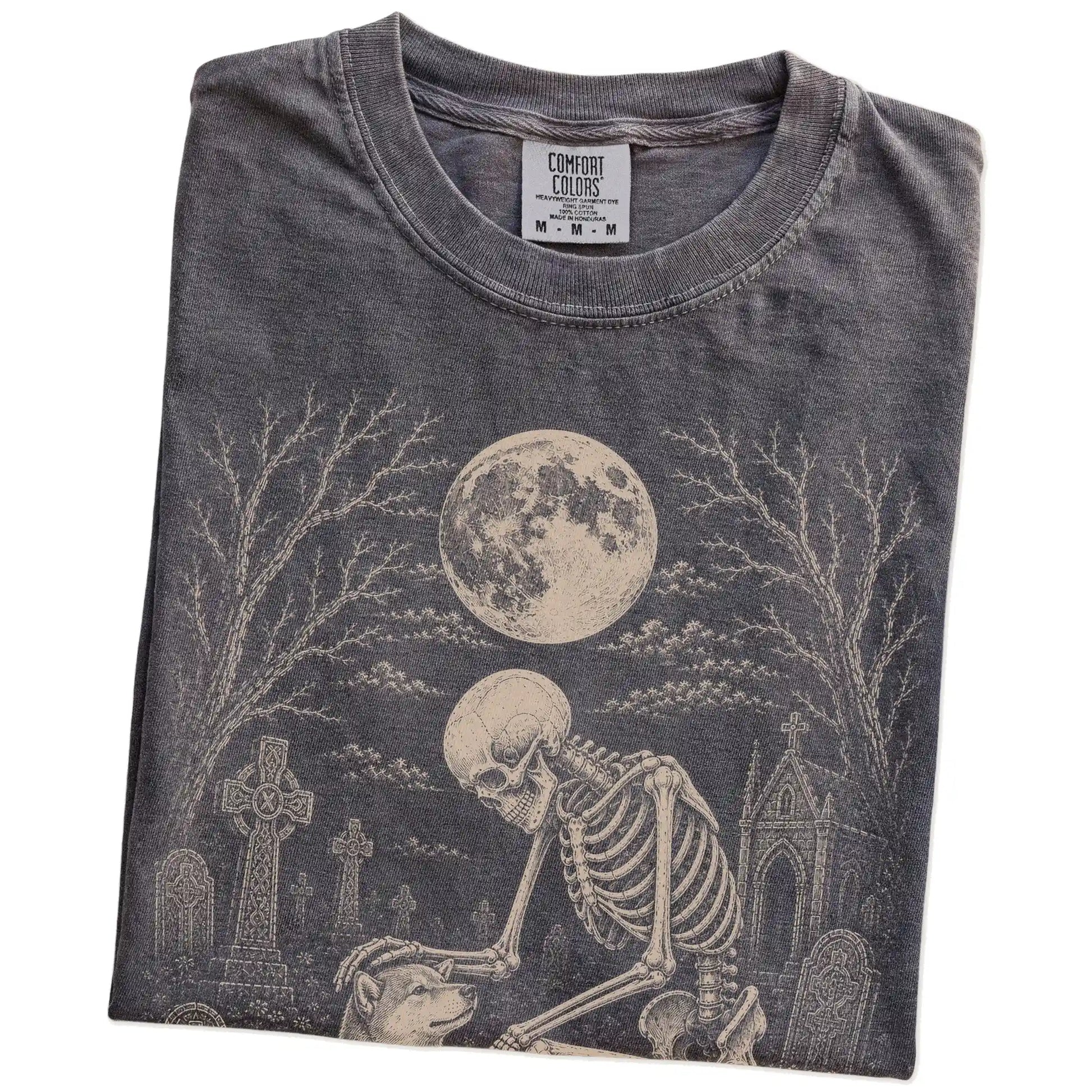 Folded Pepper Comfort Colors® T-shirt showing Shiba Inu sharing a quiet cemetery moment with a friendly skeleton
