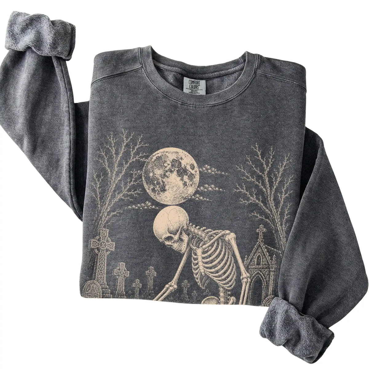 Folded Pepper sweatshirt with a skeleton petting a Shih Tzu in a graveyard