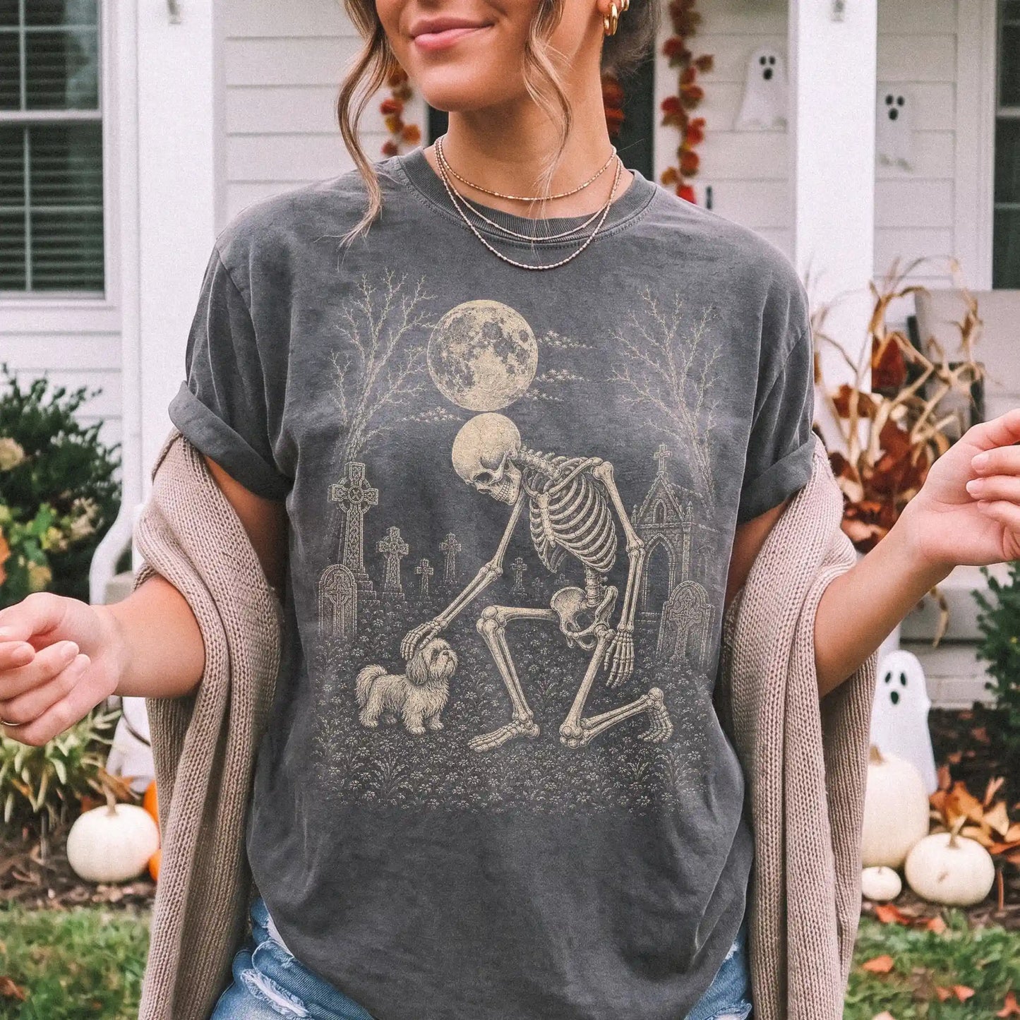 Model wearing a Pepper Comfort Colors® T-shirt showing Shih Tzu sharing a quiet cemetery moment with a friendly skeleton
