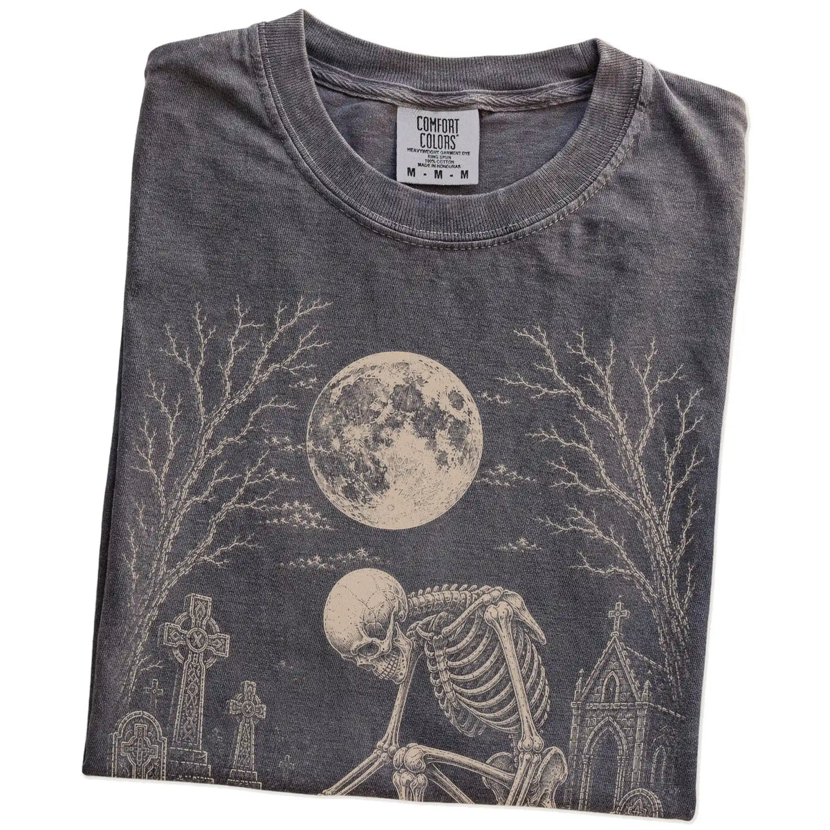Folded Pepper Comfort Colors® T-shirt showing Westie sharing a quiet cemetery moment with a friendly skeleton