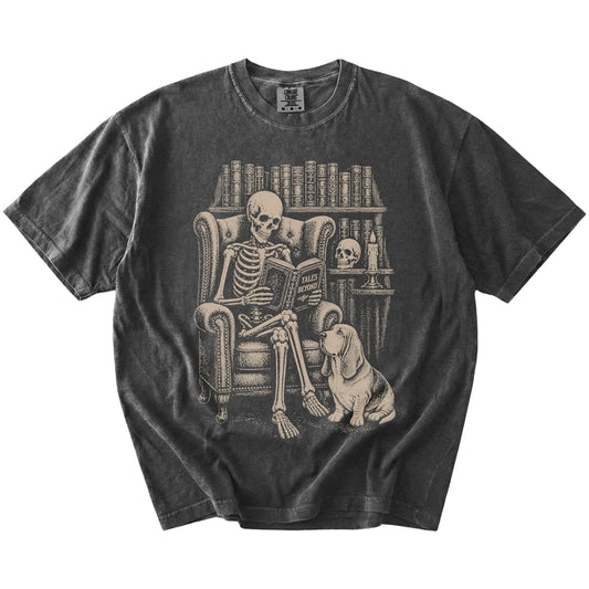 Skeleton reading in a library beside a Basset Hound on a Pepper Comfort Colors® T-shirt