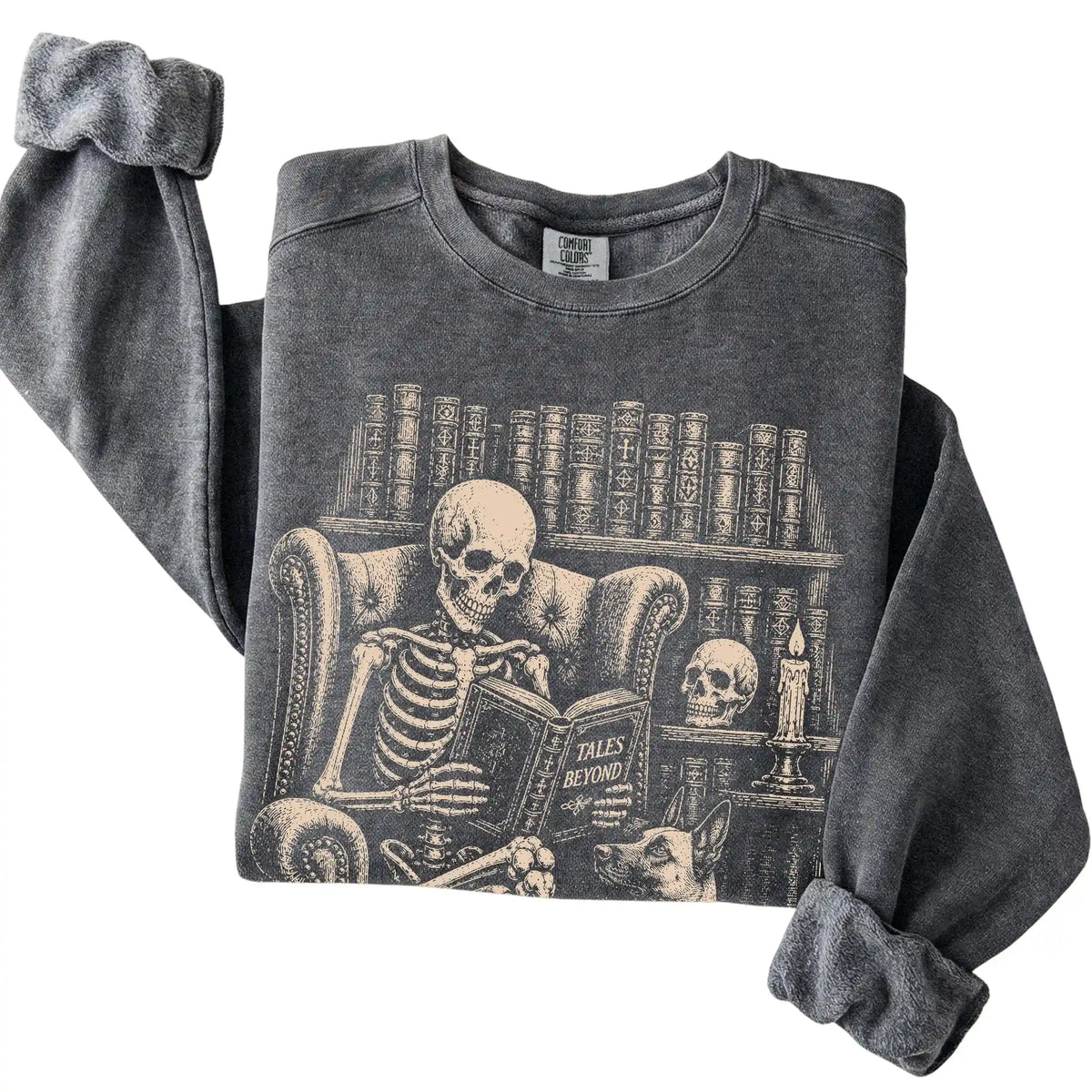 Folded Pepper sweatshirt with a skeleton reading Tales Beyond to a Belgian Malinois
