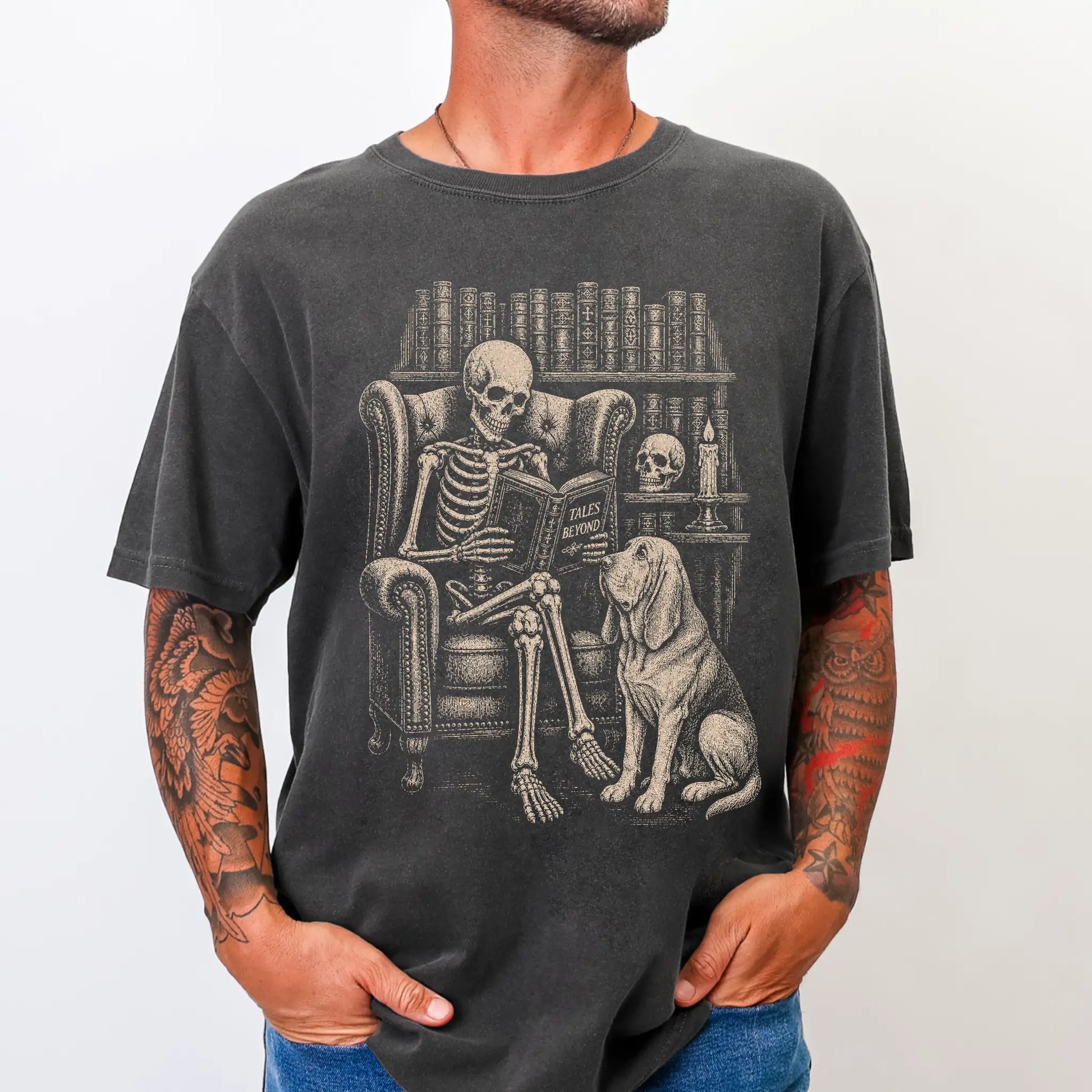 Model wearing a Pepper Comfort Colors® T-shirt showing skeleton reading in a library beside a Bloodhound