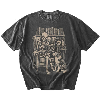 Skeleton reading in a library beside a Border Collie on a Pepper Comfort Colors® T-shirt
