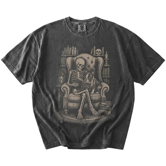 Skeleton reading in a library beside a Boston Terrier on a Pepper Comfort Colors® T-shirt