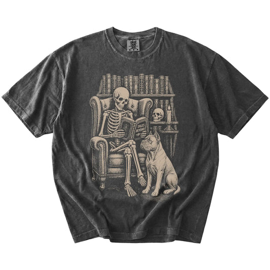 Skeleton reading in a library beside a Cane Corso on a Pepper Comfort Colors® T-shirt