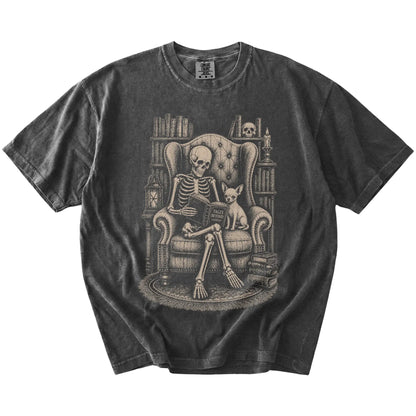 Skeleton reading in a library beside a Chihuahua on a Pepper Comfort Colors® T-shirt