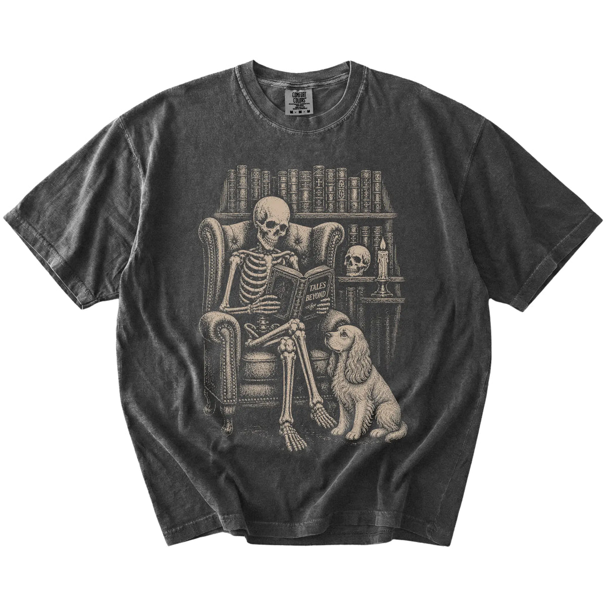 Skeleton reading in a library beside a Cocker Spaniel on a Pepper Comfort Colors® T-shirt