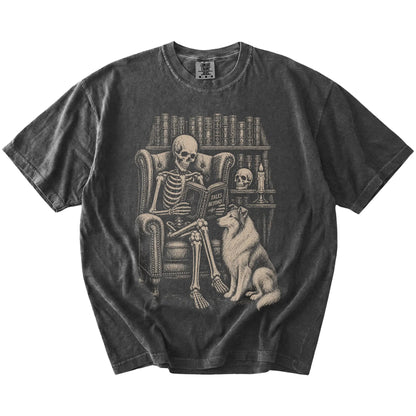 Skeleton reading in a library beside a Collie on a Pepper Comfort Colors® T-shirt