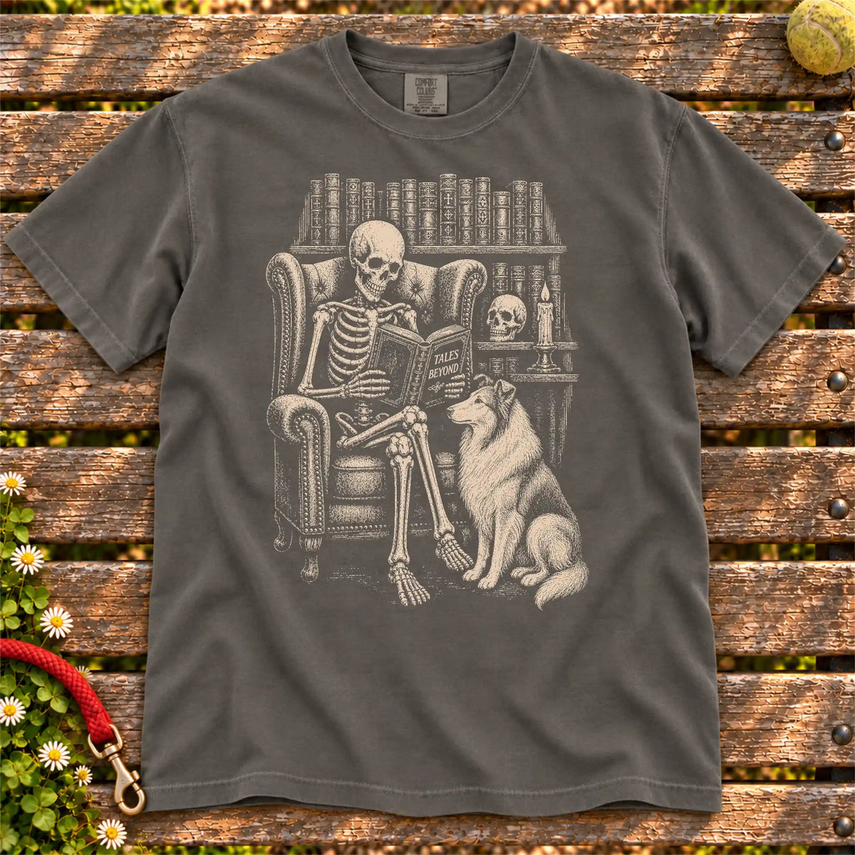 Skeleton reading in a library beside a Collie on a Pepper Comfort Colors® T-shirt