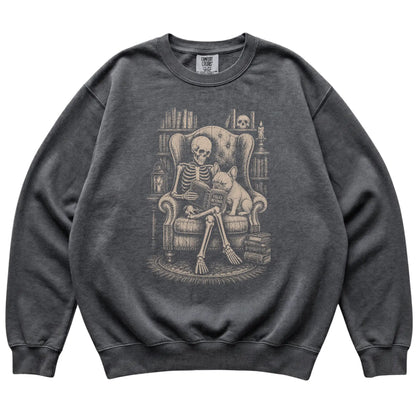 Skeleton reading Tales Beyond to a French Bulldog on a Pepper sweatshirt