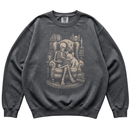 Skeleton reading Tales Beyond to a French Bulldog on a Pepper sweatshirt