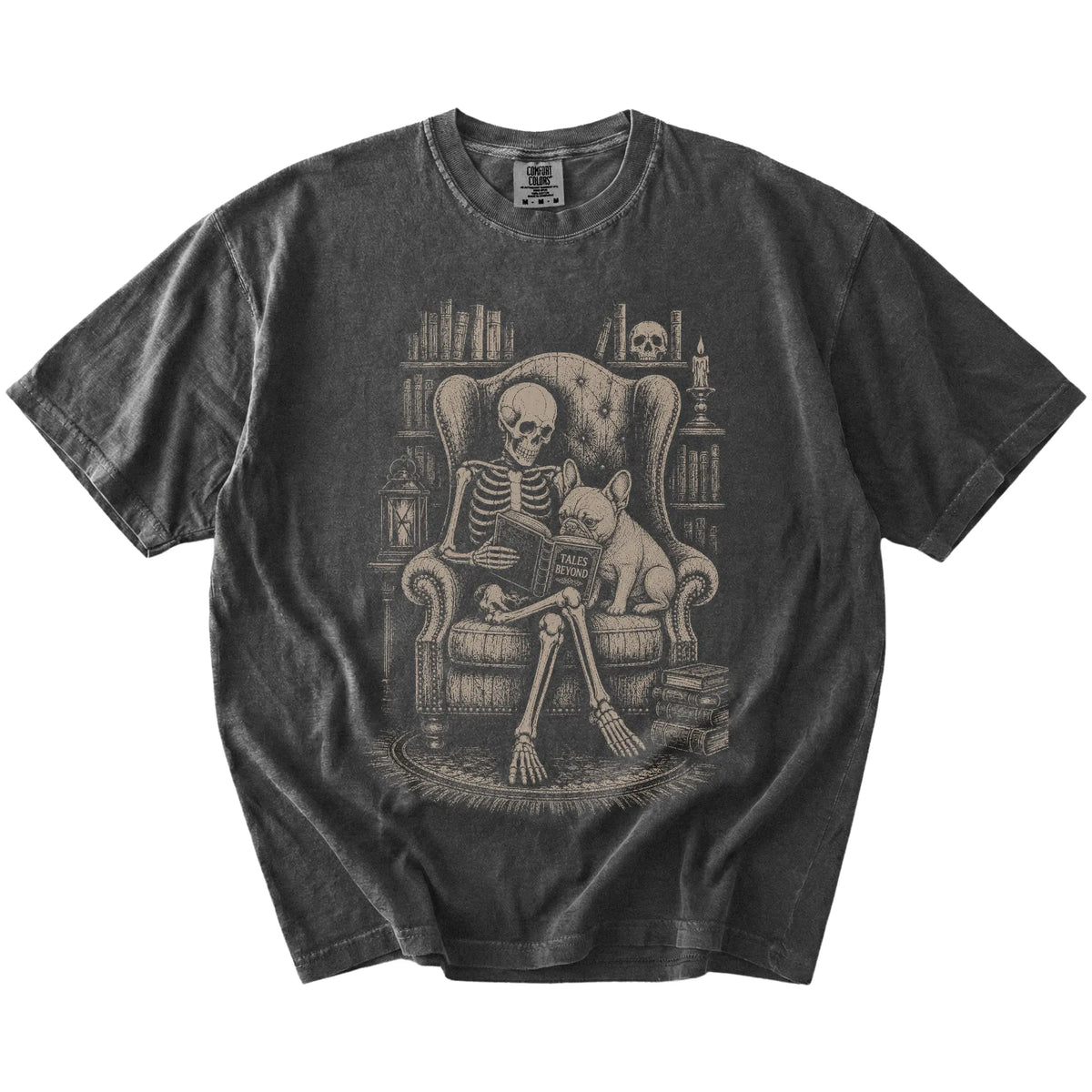 Skeleton reading in a library beside a French Bulldog on a Pepper Comfort Colors® T-shirt