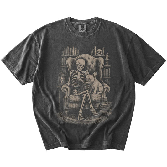 Skeleton reading in a library beside a French Bulldog on a Pepper Comfort Colors® T-shirt