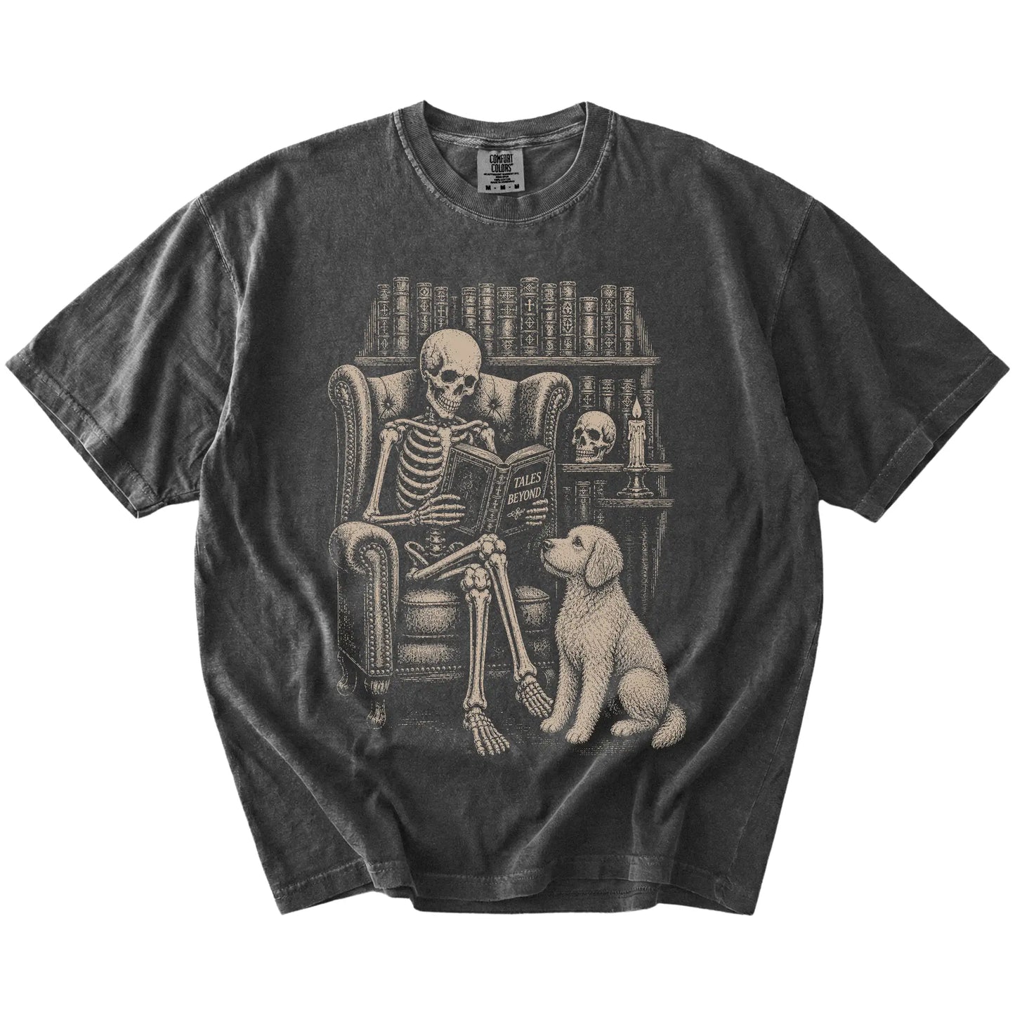 Skeleton reading in a library beside a Goldendoodle on a Pepper Comfort Colors® T-shirt