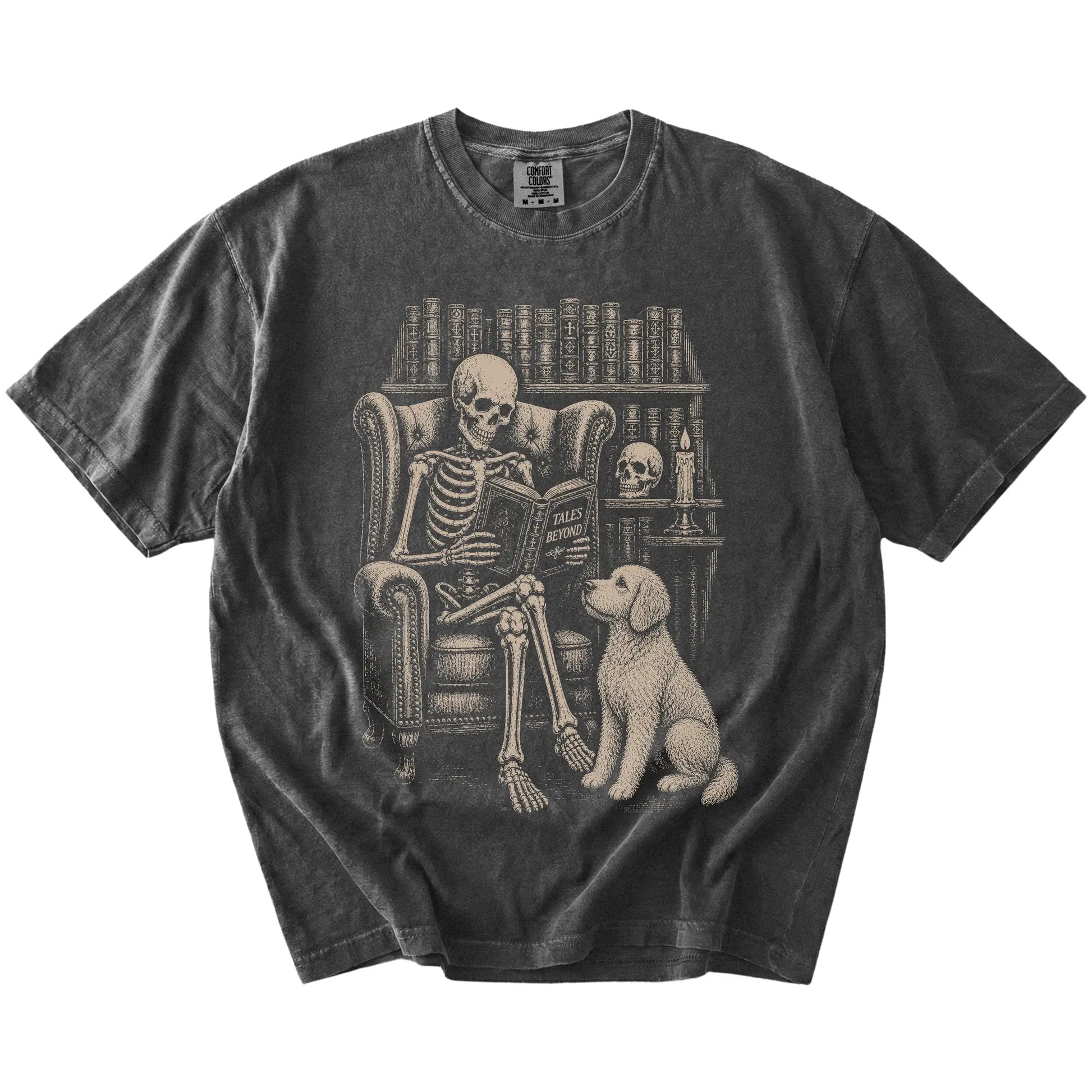 Skeleton reading in a library beside a Goldendoodle on a Pepper Comfort Colors® T-shirt