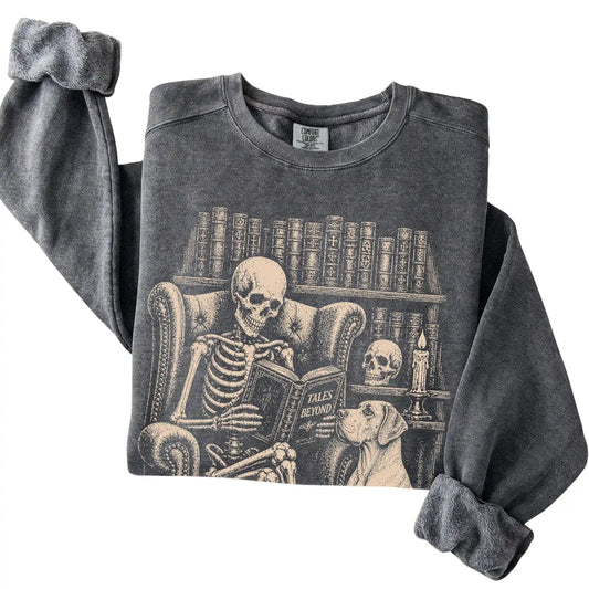 Folded Pepper sweatshirt with a skeleton reading Tales Beyond to a Great Dane