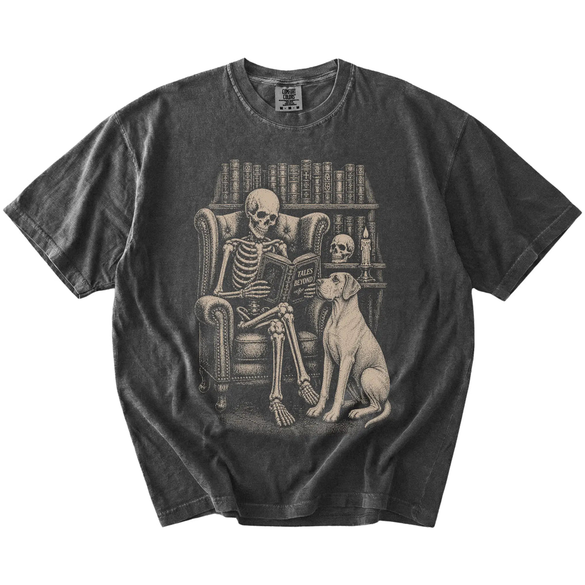 Skeleton reading in a library beside a Great Dane on a Pepper Comfort Colors® T-shirt