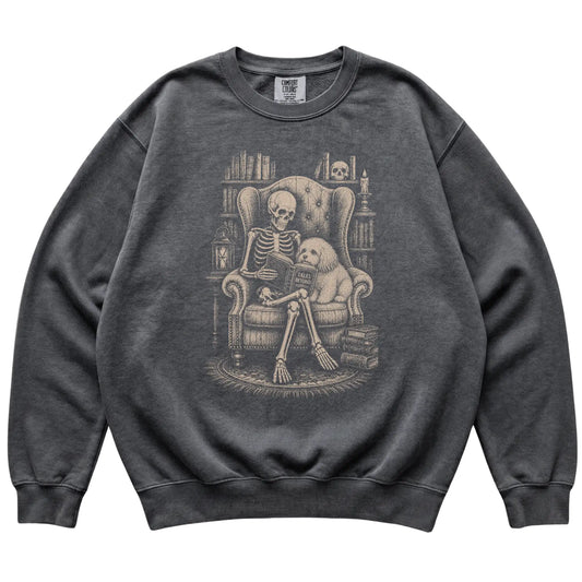 Skeleton reading Tales Beyond to a Havanese on a Pepper sweatshirt