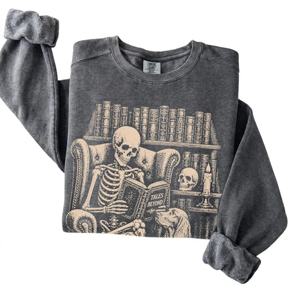 Folded Pepper sweatshirt with a skeleton reading Tales Beyond to an Irish Setter