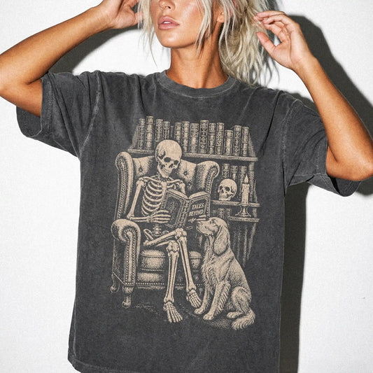 Model wearing a Pepper Comfort Colors® T-shirt showing skeleton reading in a library beside a Irish Setter