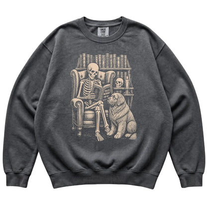 Skeleton reading Tales Beyond to a Newfie on a Pepper sweatshirt