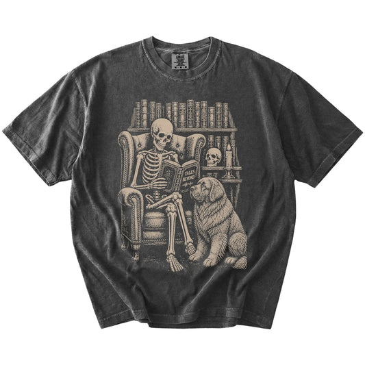 Skeleton reading in a library beside a Newfie on a Pepper Comfort Colors® T-shirt