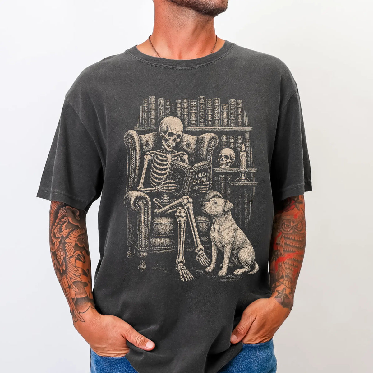 Model wearing a Pepper Comfort Colors® T-shirt showing skeleton reading in a library beside a Pitbull