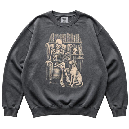 Skeleton reading Tales Beyond to a Pointer on a Pepper sweatshirt