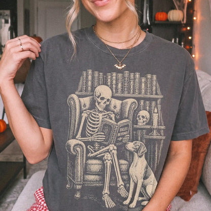 Model wearing a Pepper Comfort Colors® T-shirt showing skeleton reading in a library beside a Pointer