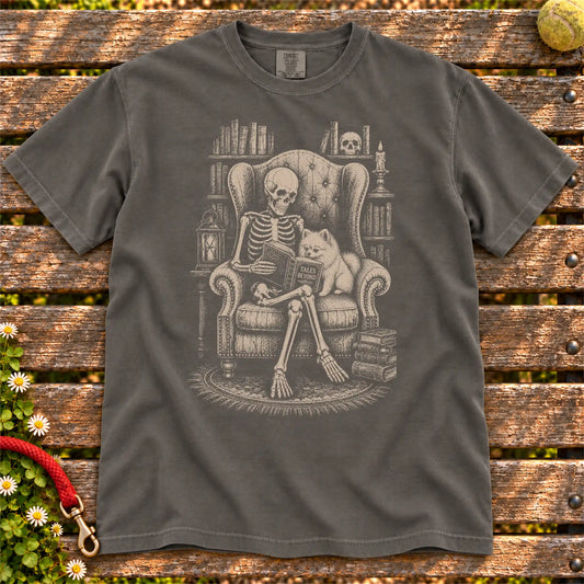 Skeleton reading in a library beside a Pomeranian on a Pepper Comfort Colors® T-shirt