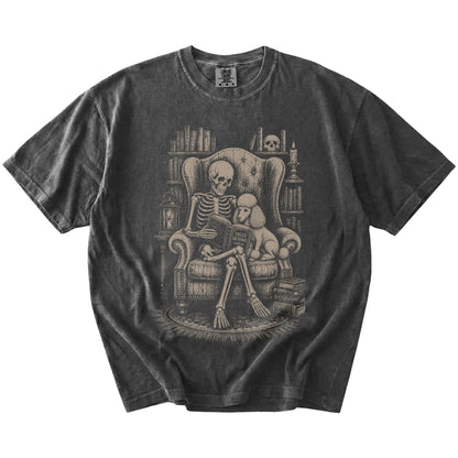 Skeleton reading in a library beside a Poodle on a Pepper Comfort Colors® T-shirt