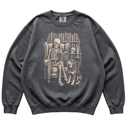 Skeleton reading Tales Beyond to a Rottweiler on a Pepper sweatshirt