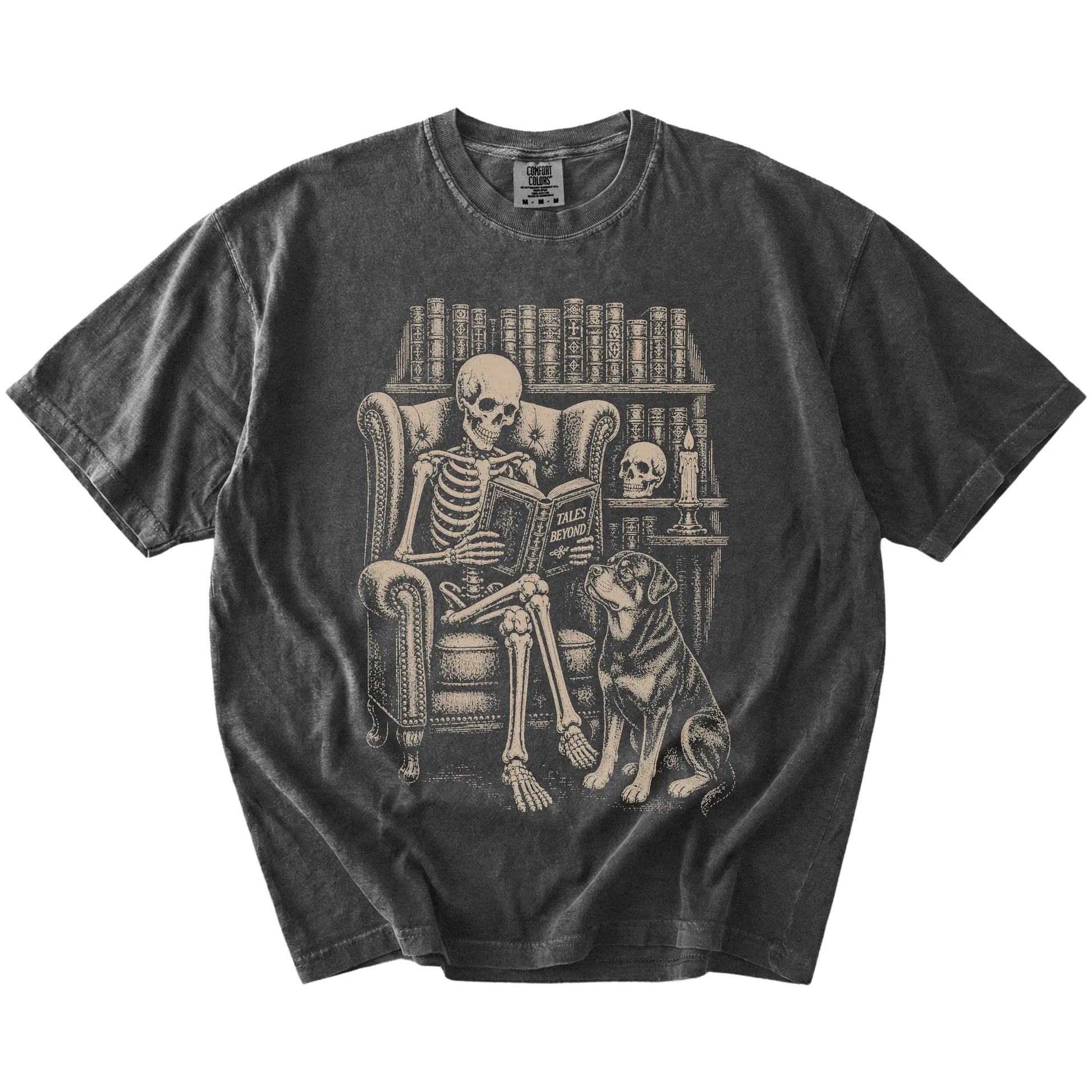 Skeleton reading in a library beside a Rottweiler on a Pepper Comfort Colors® T-shirt