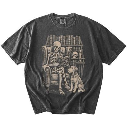 Skeleton reading in a library beside a Schnauzer on a Pepper Comfort Colors® T-shirt