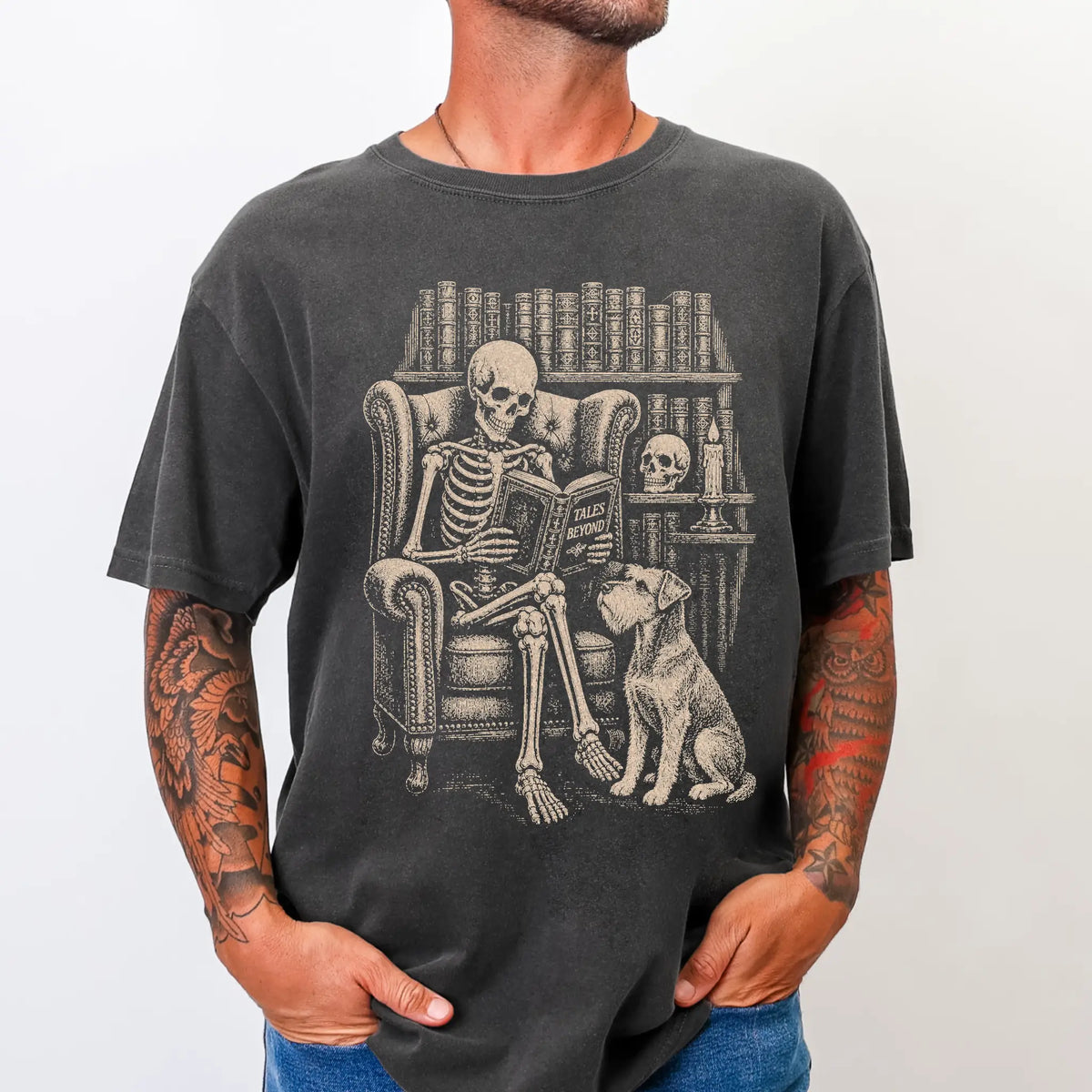 Model wearing a Pepper Comfort Colors® T-shirt showing skeleton reading in a library beside a Schnauzer
