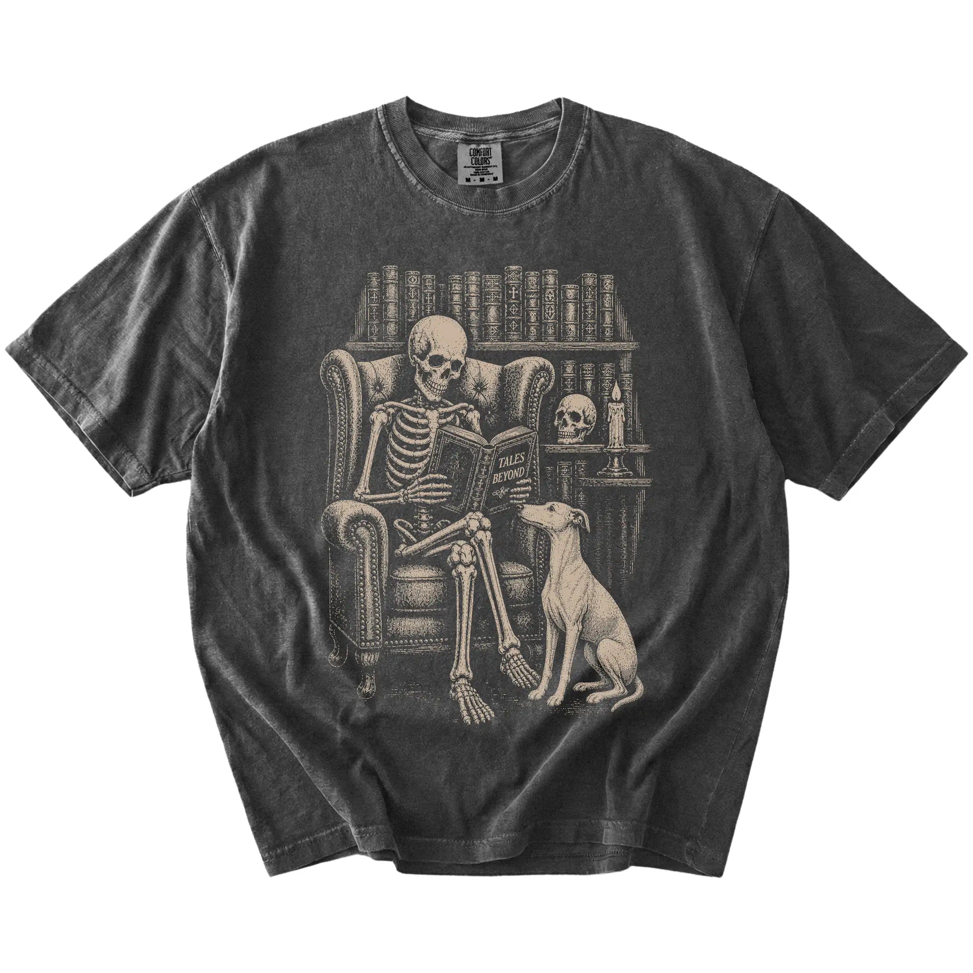 Skeleton reading in a library beside a Whippet on a Pepper Comfort Colors® T-shirt