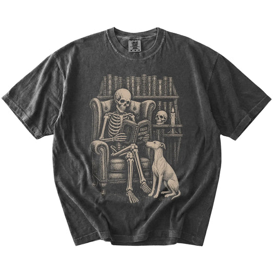 Skeleton reading in a library beside a Whippet on a Pepper Comfort Colors® T-shirt
