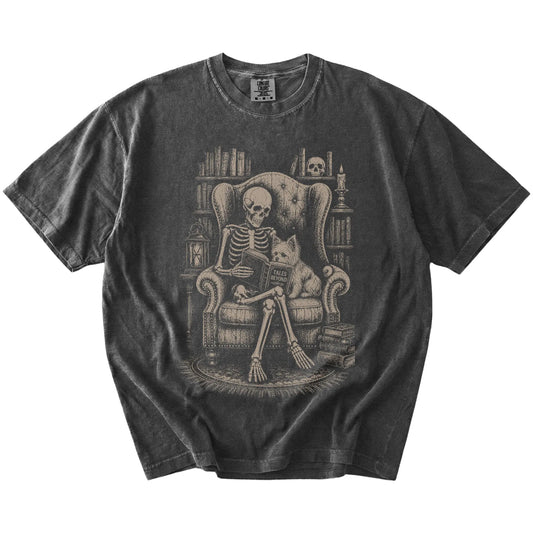 Skeleton reading in a library beside a Yorkie on a Pepper Comfort Colors® T-shirt