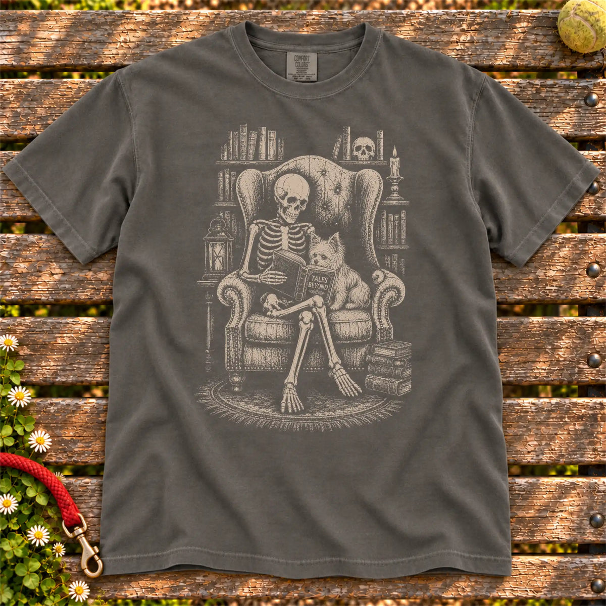 Skeleton reading in a library beside a Yorkie on a Pepper Comfort Colors® T-shirt