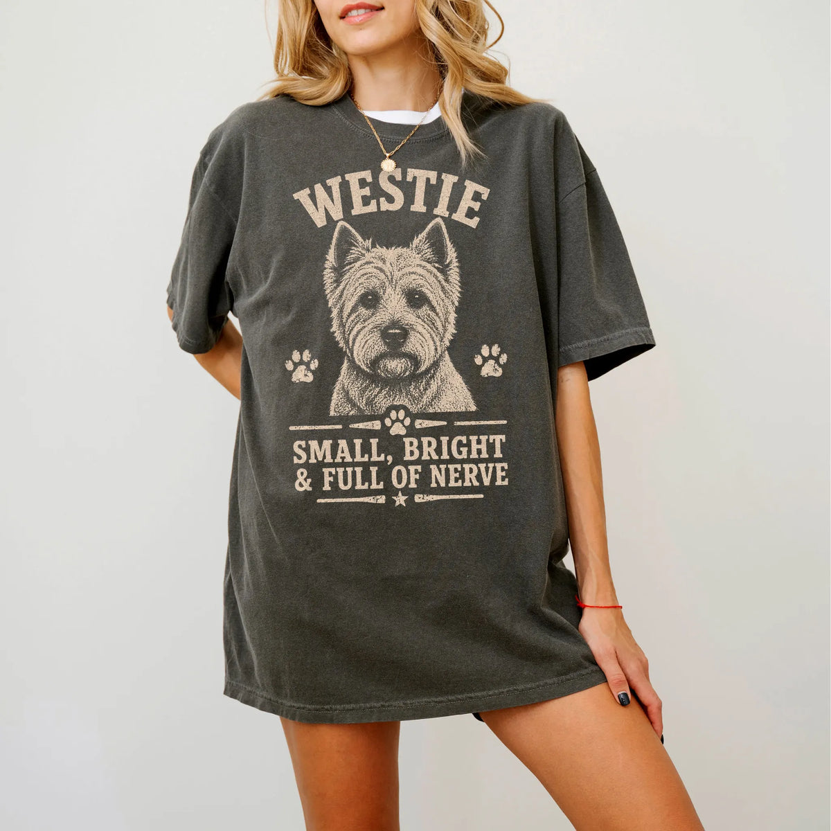 Model wearing a Pepper Comfort Colors® T-shirt featuring Westie design with “Small, Bright & Full Of Nerve” lettering