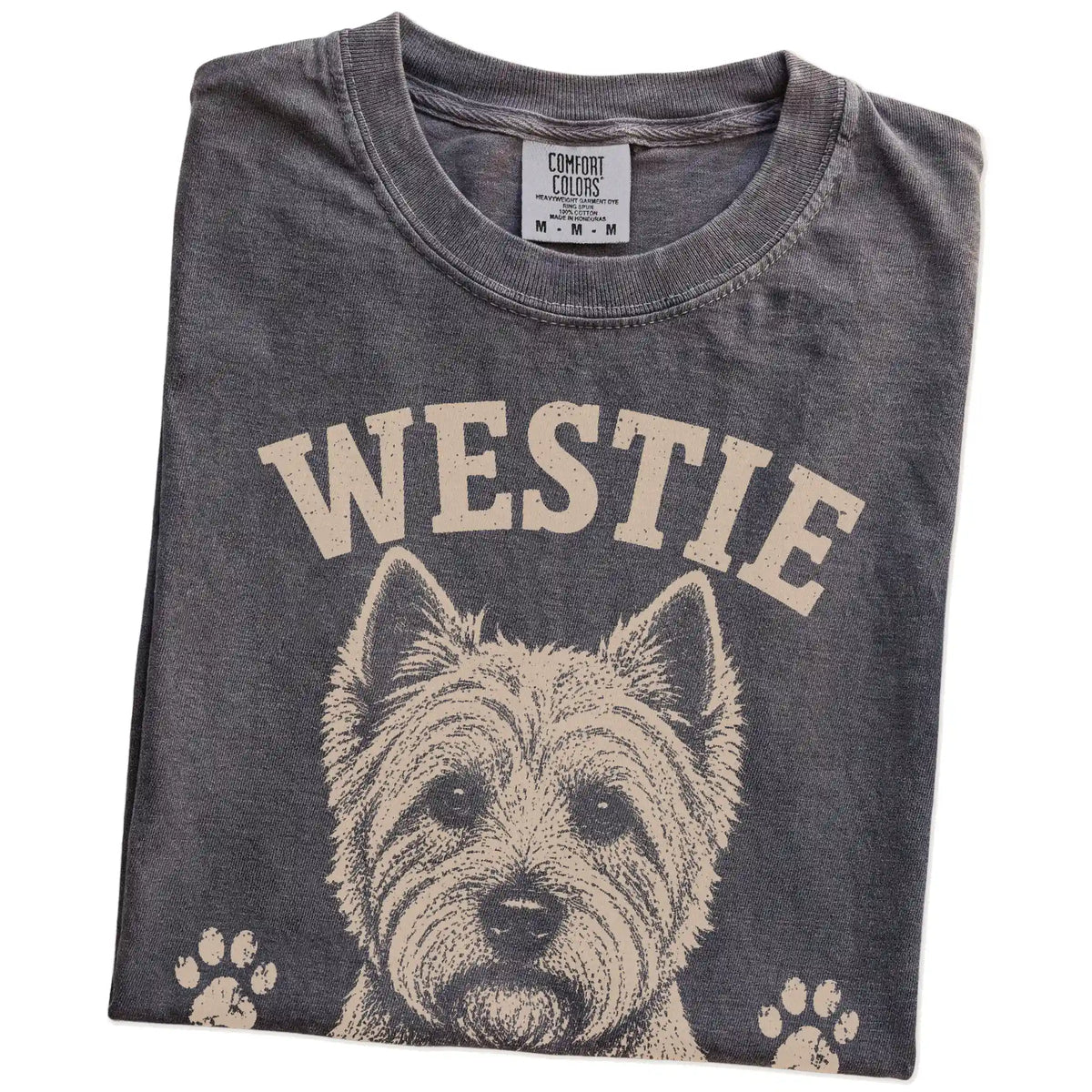 Folded Pepper Comfort Colors® T-shirt showing Westie design with “Small, Bright & Full Of Nerve” lettering