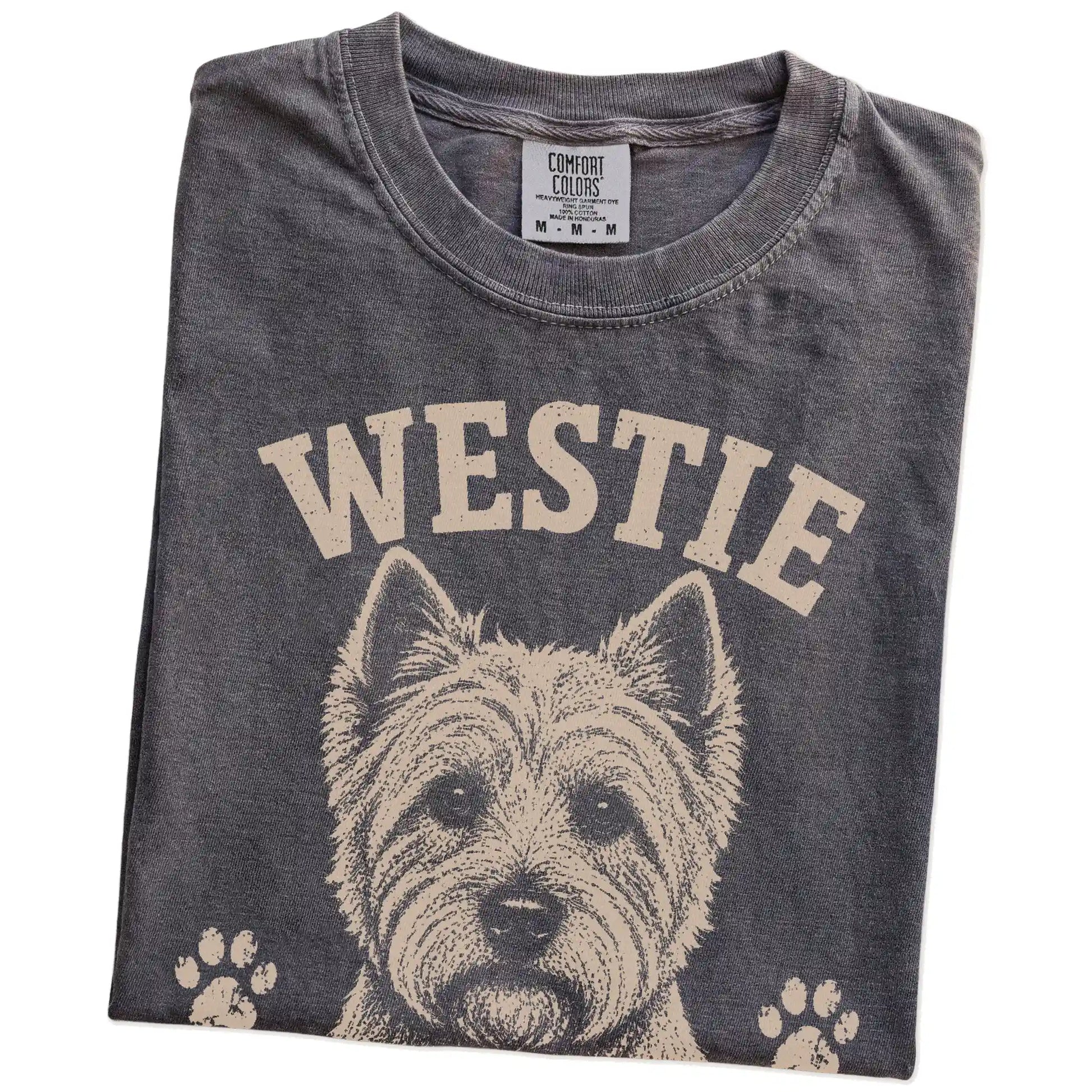 Folded Pepper Comfort Colors® T-shirt showing Westie design with “Small, Bright & Full Of Nerve” lettering