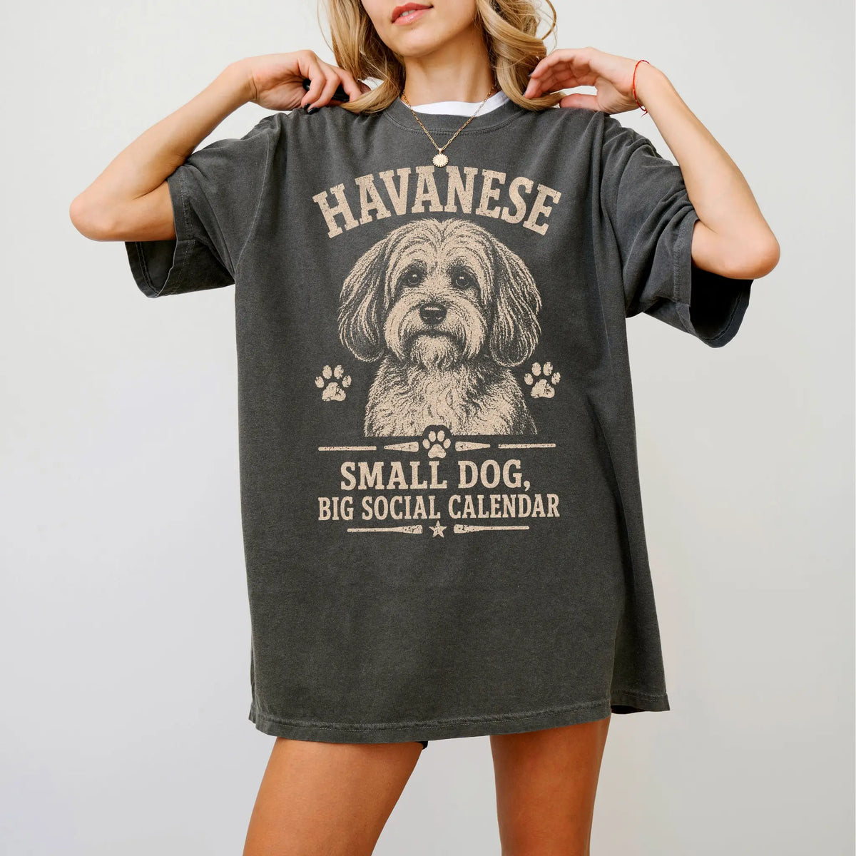 Model wearing a Pepper Comfort Colors® T-shirt featuring Havanese design with “Small Dog, Big Social Calendar” lettering