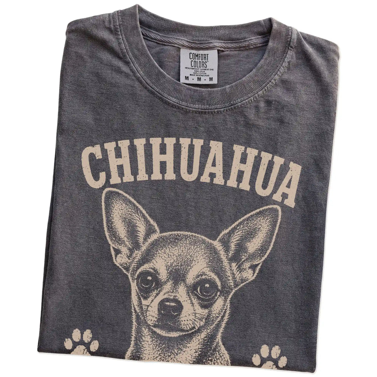 Folded Pepper Comfort Colors® T-shirt showing Chihuahua design with “Small Package, Loud Opinions” lettering