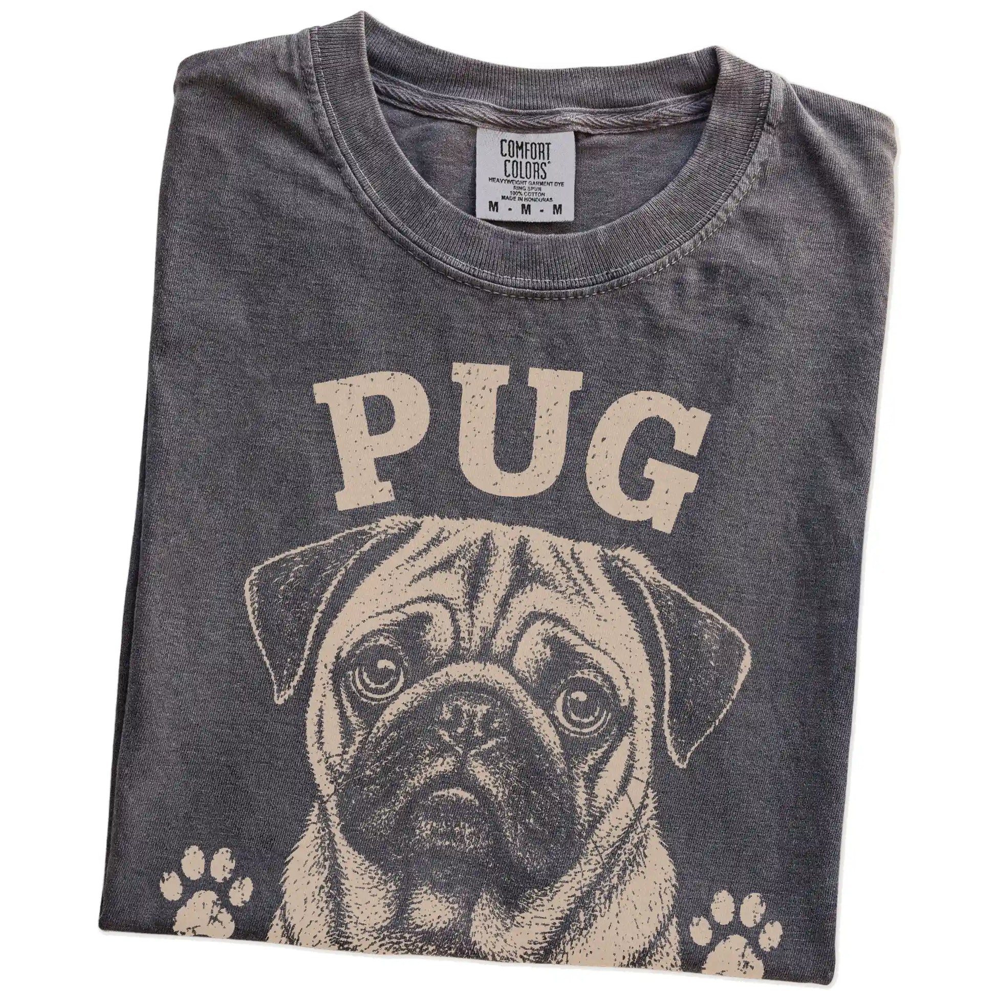 Folded Pepper Comfort Colors® T-shirt showing Pug design with “Snore Loud, Love Hard” lettering