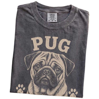Folded Pepper Comfort Colors® T-shirt showing Pug design with “Snore Loud, Love Hard” lettering