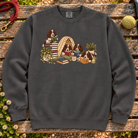 Springer Spaniel puppies reading books in a cozy blanket fort on a Pepper sweatshirt