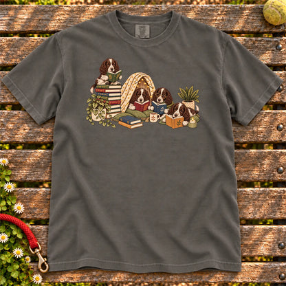 Springer Spaniel puppies reading books in a cozy blanket fort on a Pepper T-shirt