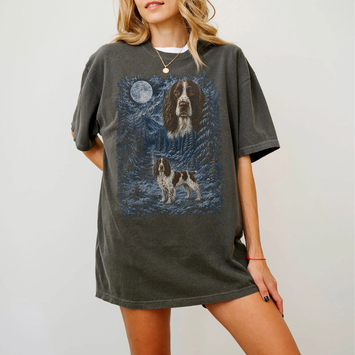 Model wearing a pepper T-shirt with Springer Spaniel Winter Moon artwork.